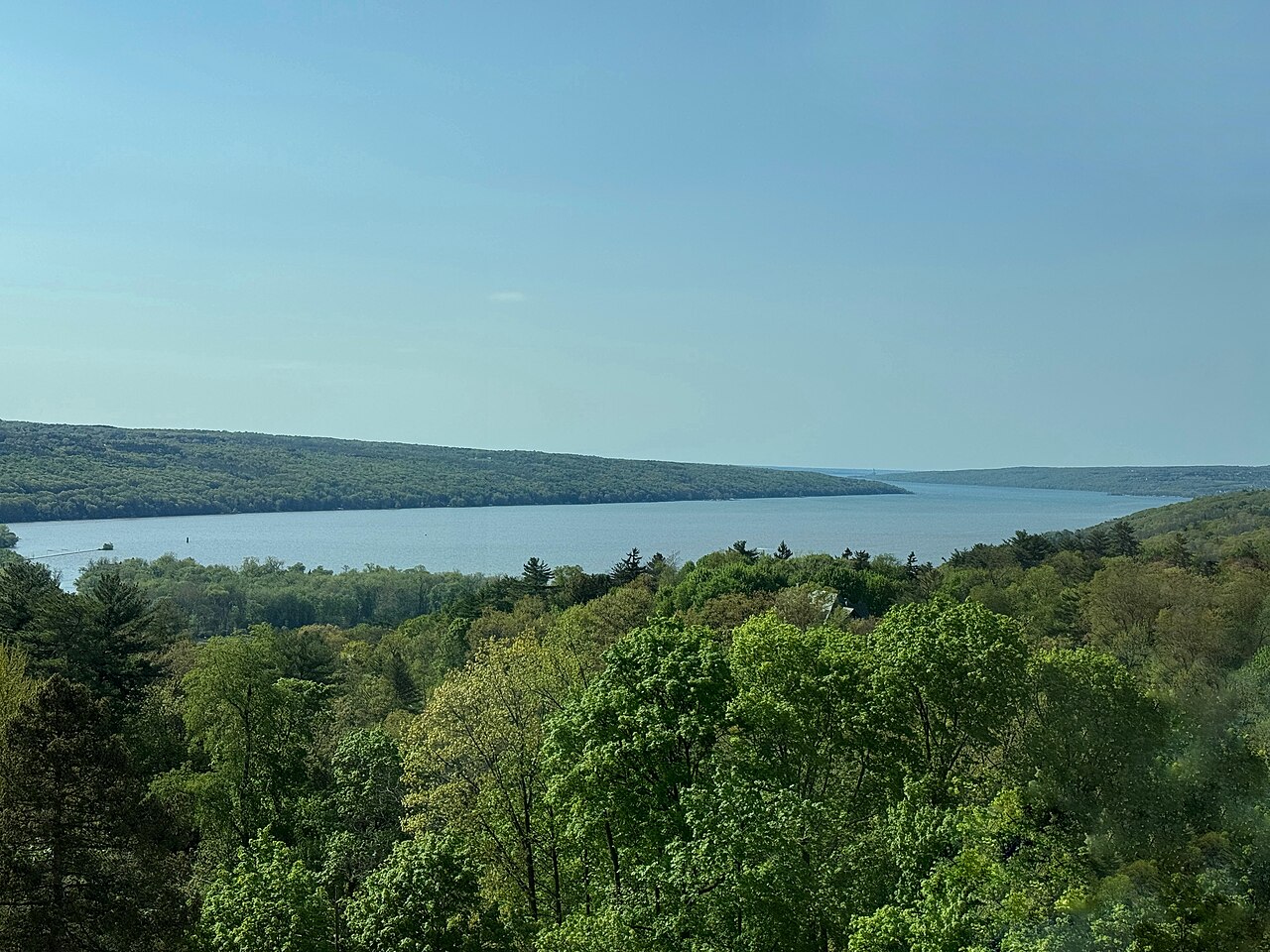 Cayuga Lake stretching north between green hills under a spring sky.