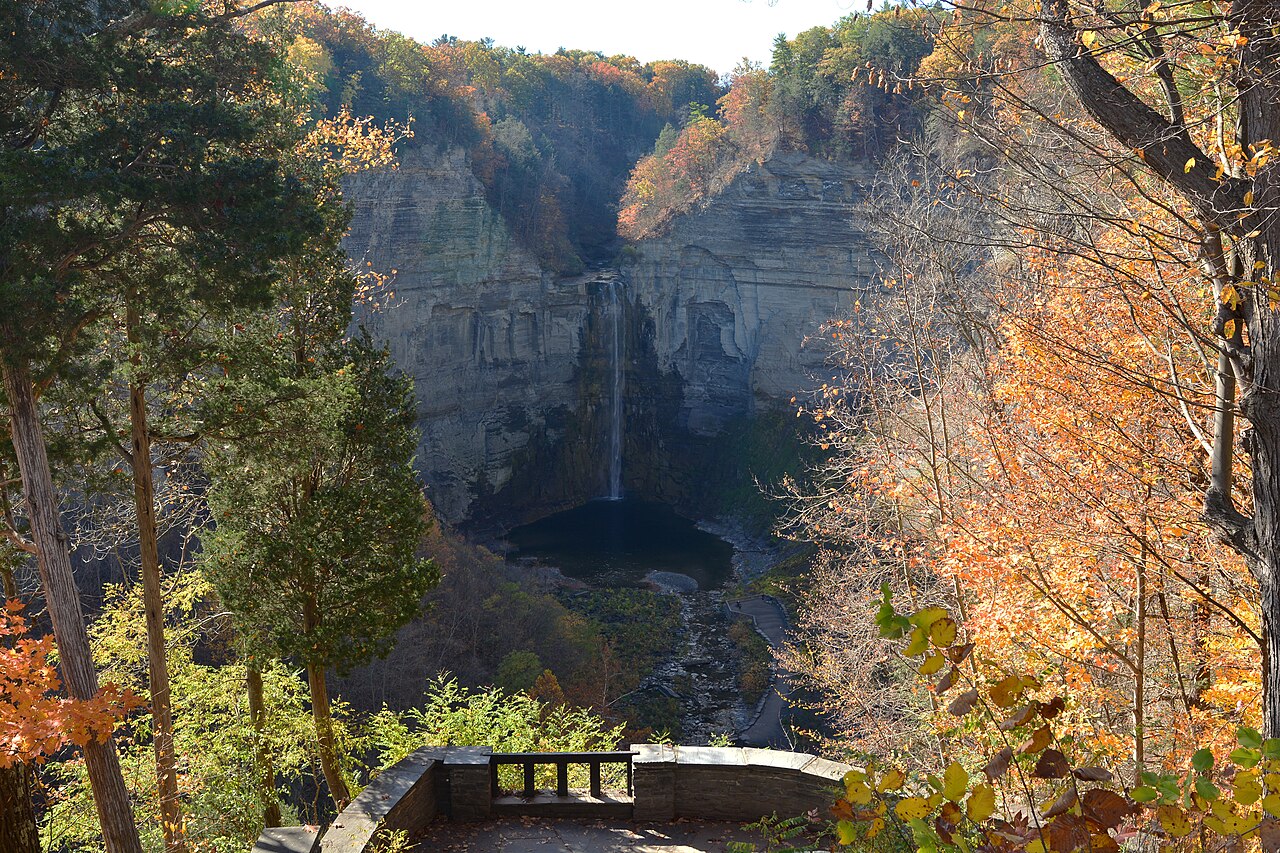 Taughannock Falls plunging into its gorge amid autumn foliage, viewed from the overlook.